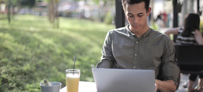A man sitting outside and using laptop
