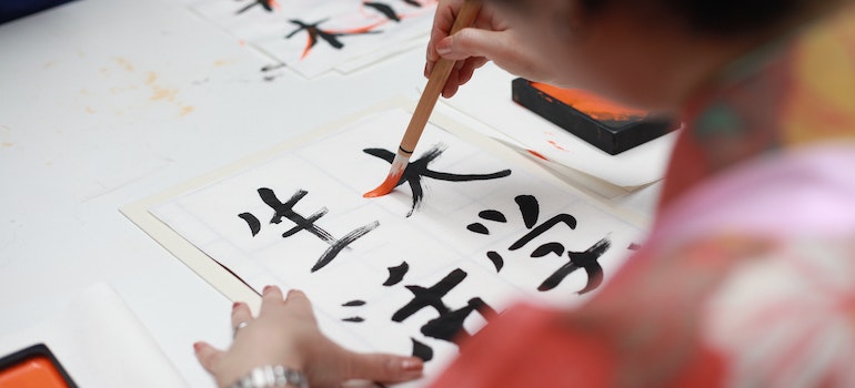 A woman drawing kanji script
