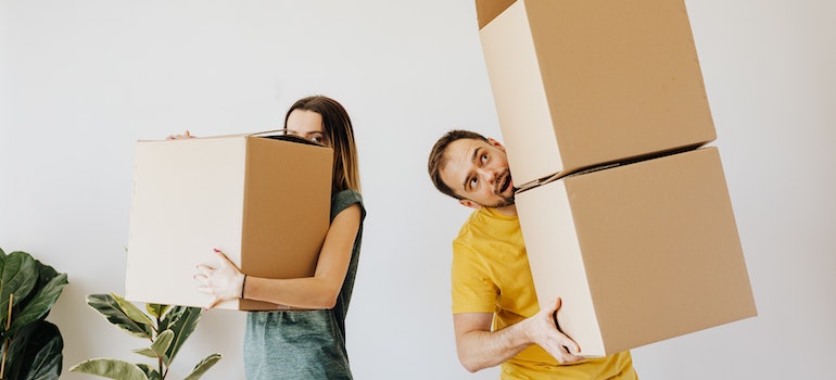 couple handling moving boxes