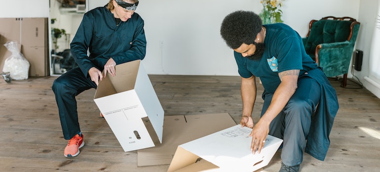 movers packing cardboard boxes