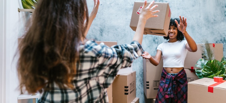 People throwing boxes after moving from Colorado to Kansas