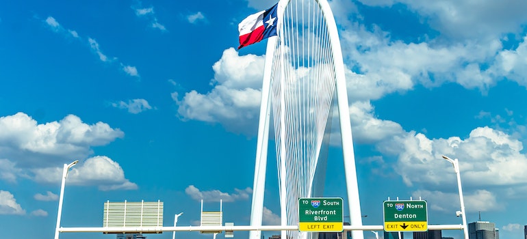 Texas flag on a interstate sign leading to some of the best cities for job seekers in Texas