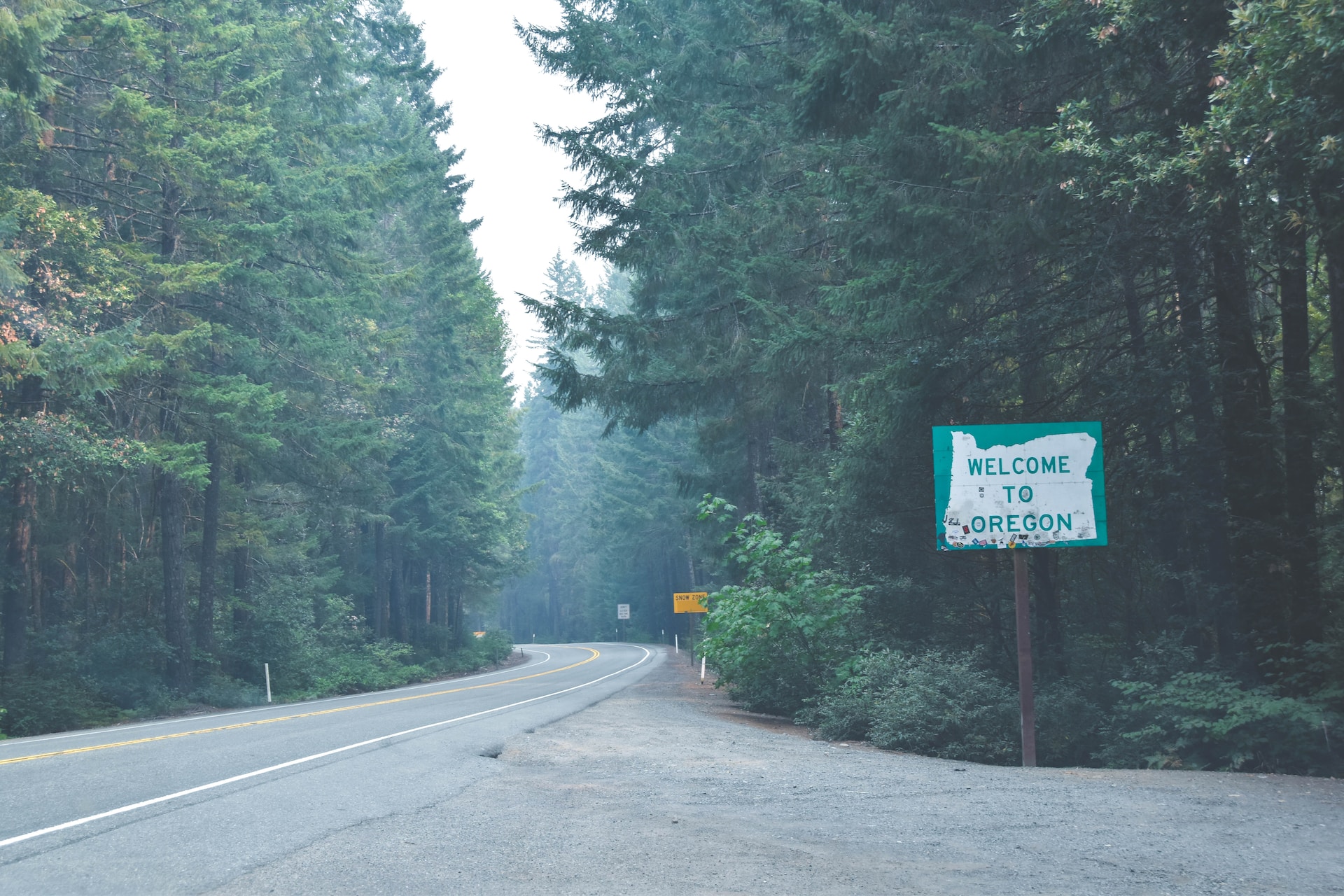Welcome to Oregon sign in a forest