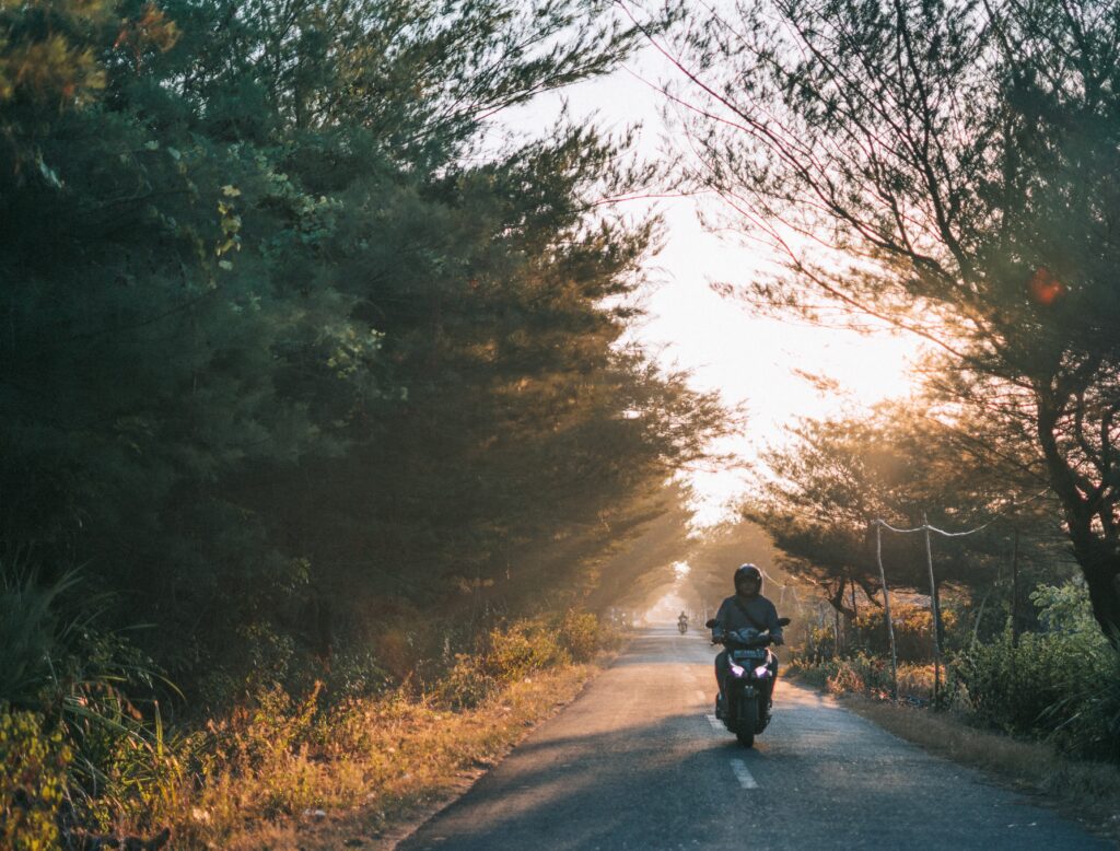 Person riding a motorcycle on a country road