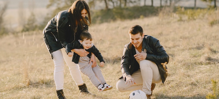 Parent playing with their small son wearing a leather jacket