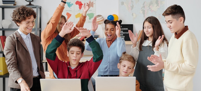 Kids celebrating in school with their teacher