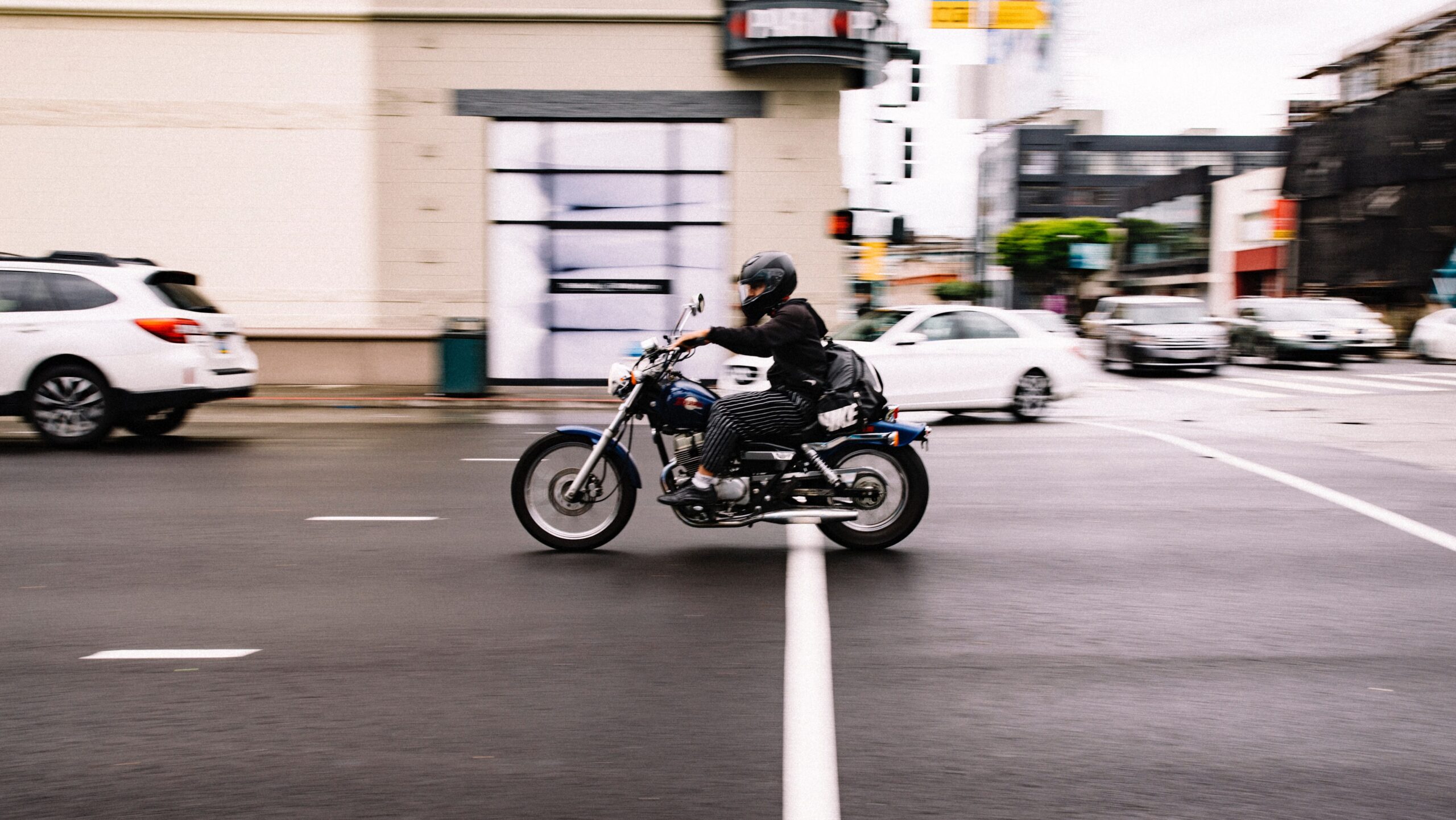 Person riding a motorcycle through a city street
