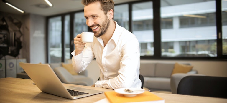 a happy man drinking coffee