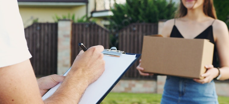 a girl holding a box and preparing for a local move in san francisco