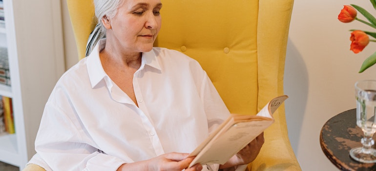 an elderly lady reading a book