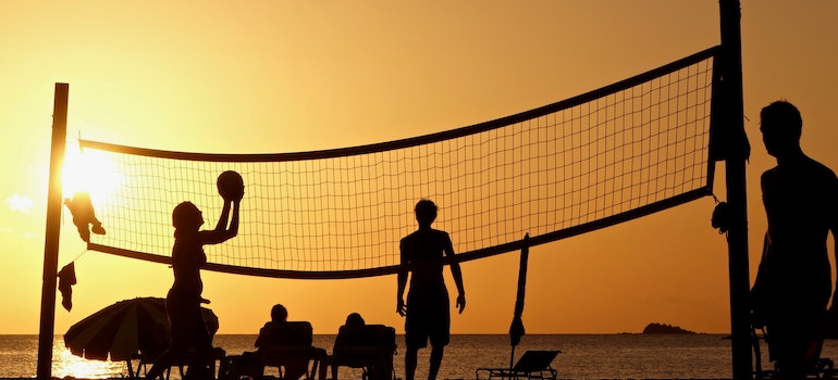 People playing volleyball on the beach