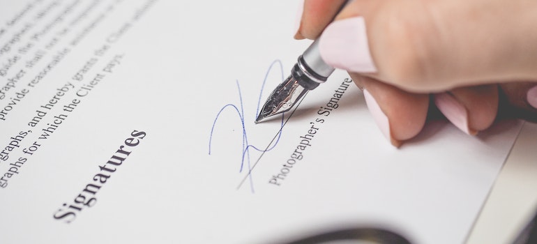 a person signing car shipping contract