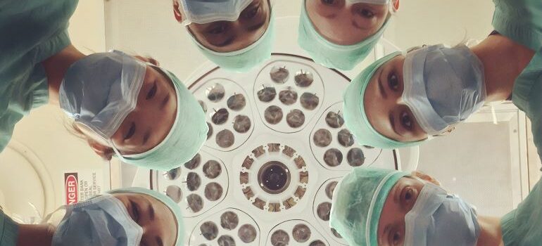 eight surgeons standing in a circle