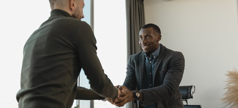 Two people shaking hands after a successful interview