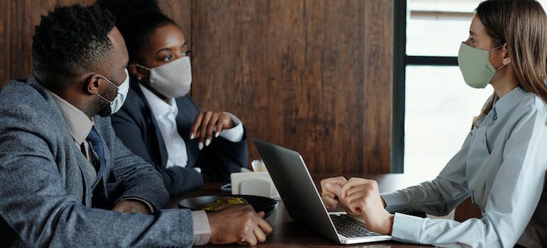 business people wearing face masks and talking