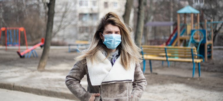 woman walking and wearing face mask