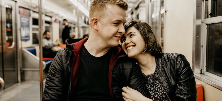 a couple sitting inside a train