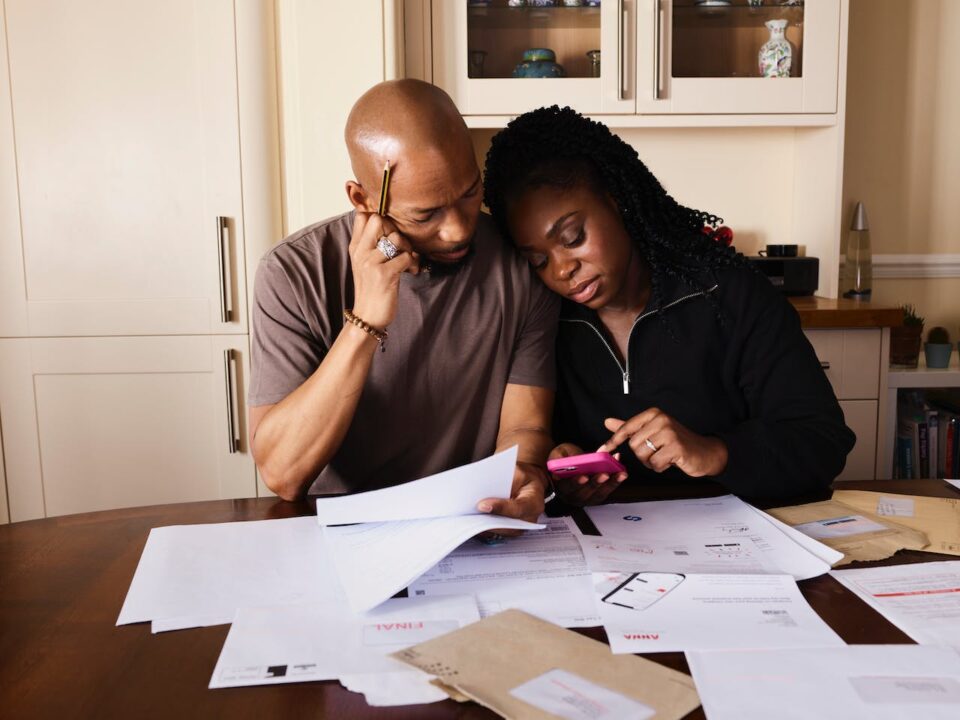 a couple sitting and budgeting for an international move