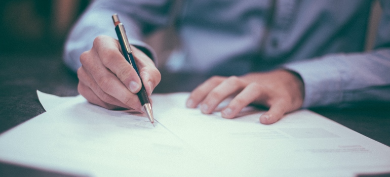 Picture of a person signing a document 