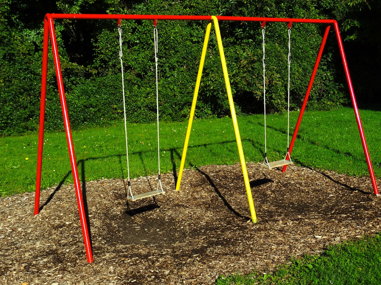 red and yellow swing set outdoor