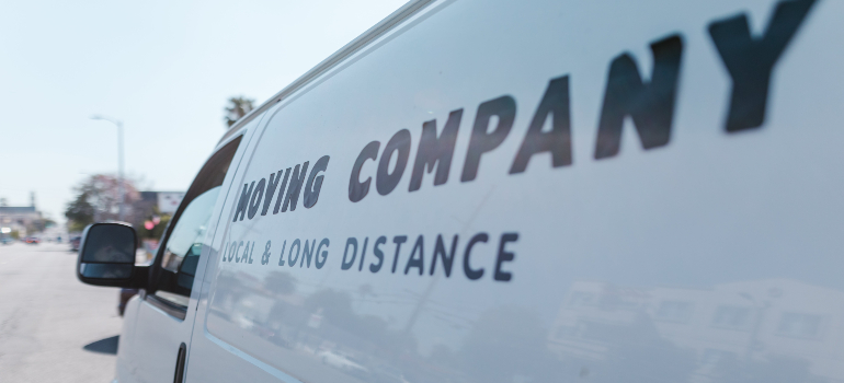 Side view of a moving company van with the text 