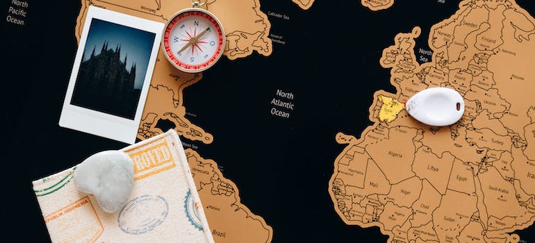 map, a photo, passport and compass