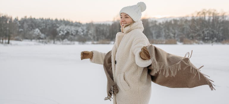woman enjoying snow after moving from Washington DC to Boston