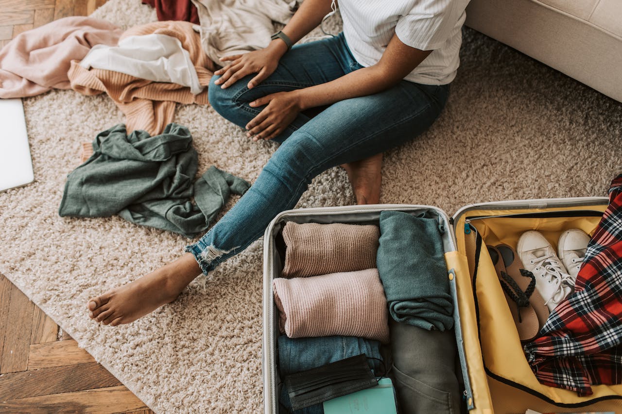 person packing a suitcase after reading about moving abroad packing tips