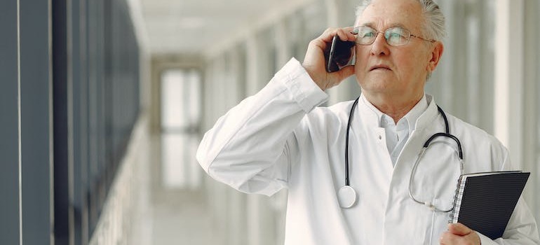 A doctor talking with someone over the phone