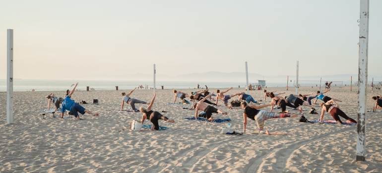 Picture of people doing yoga on the beach 