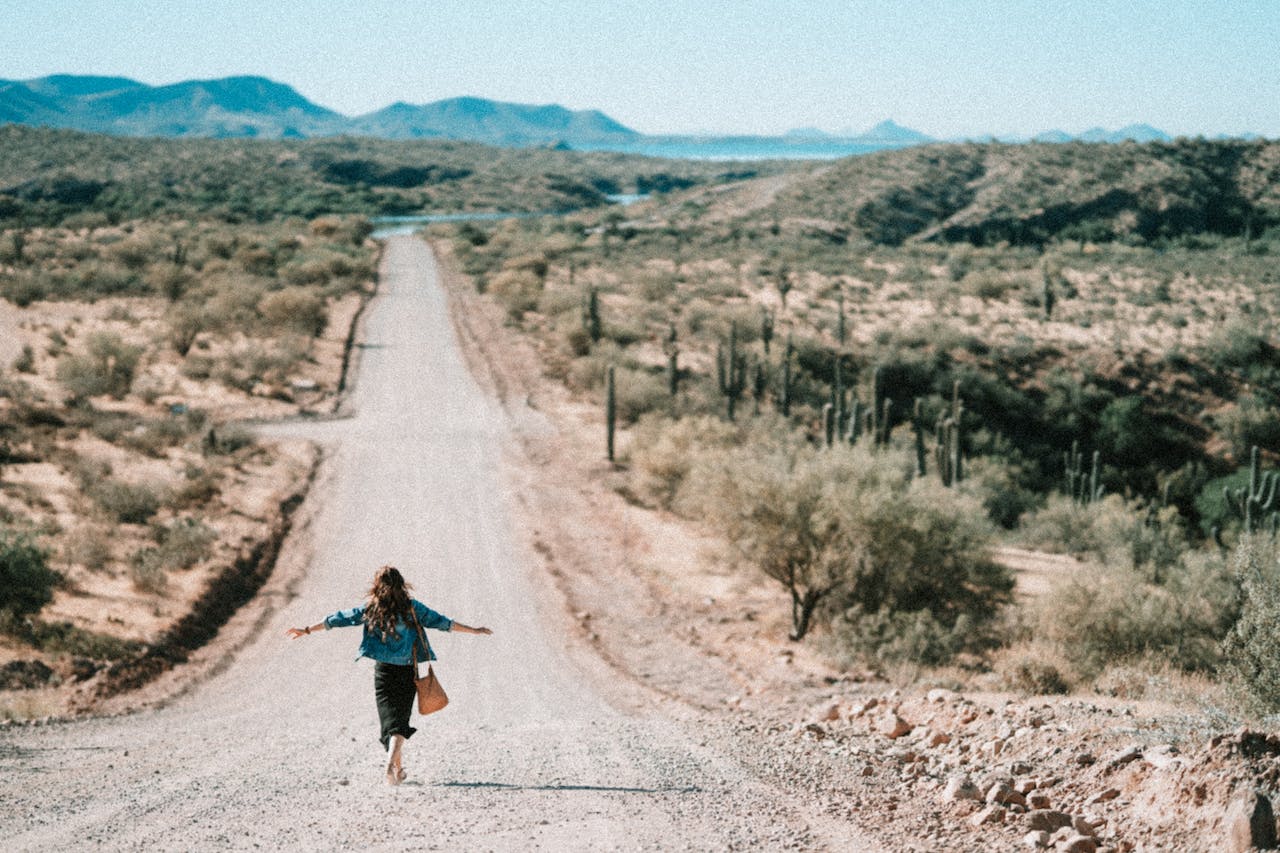 girl walking on a road in one of the best commuter towns to Phoenix