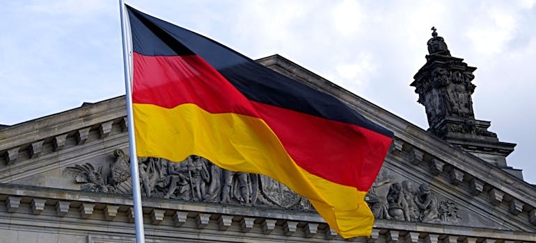 A German flag in front of a building