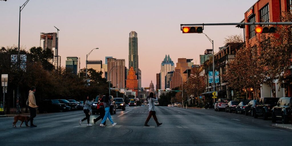 People crossing a street in Austin after moving with one of the long distance moving companies in Texas