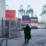 a man standing in a cargo port