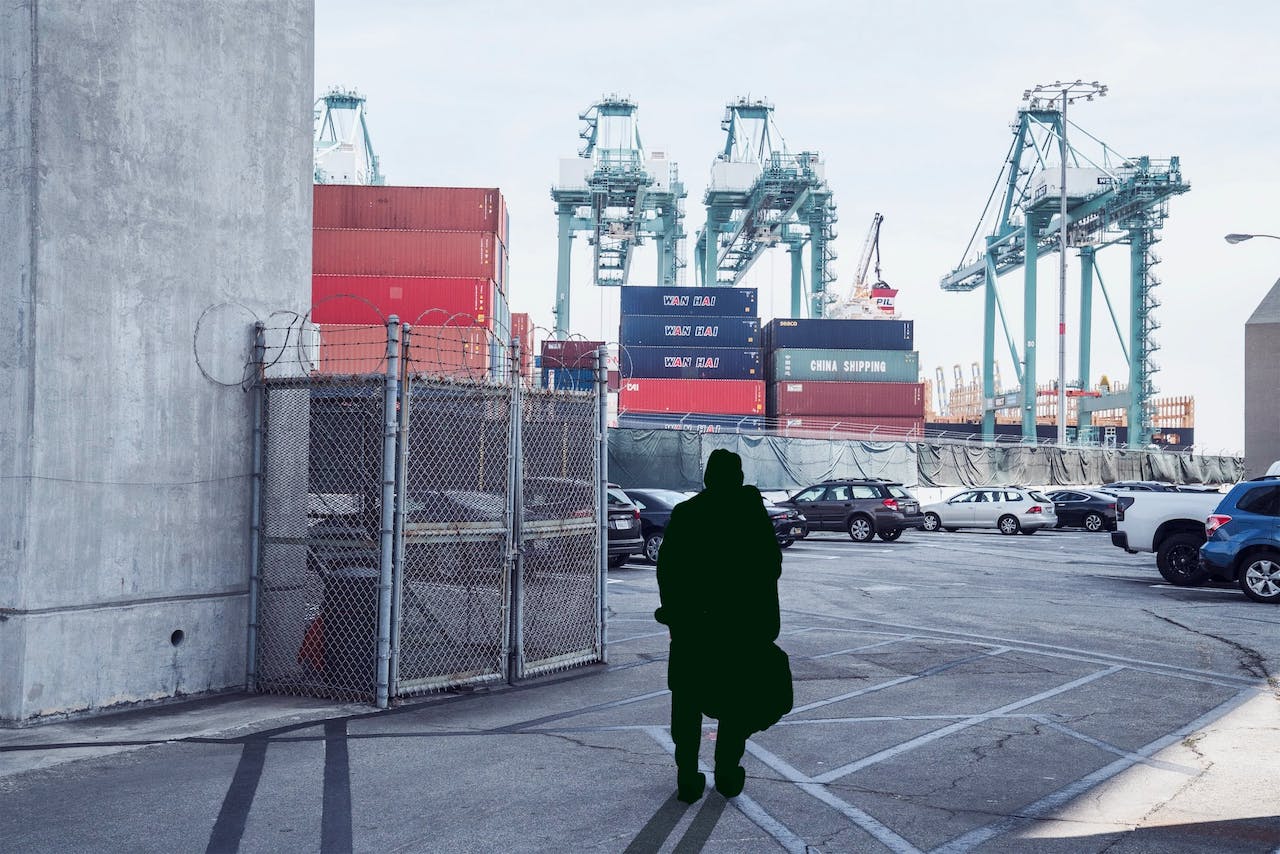 a man standing in a cargo port