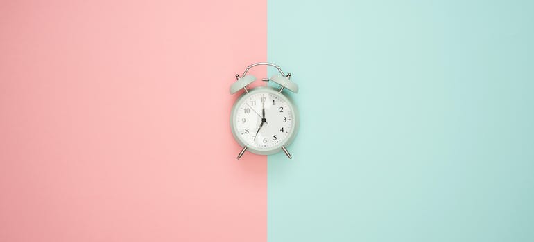a clock on pink and blue surface
