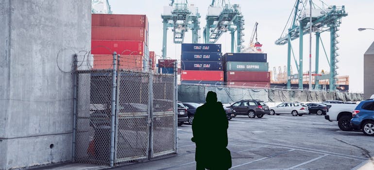 man standing in cargo port