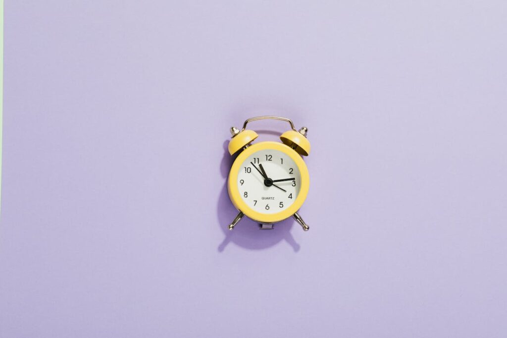yellow clock on purple surface