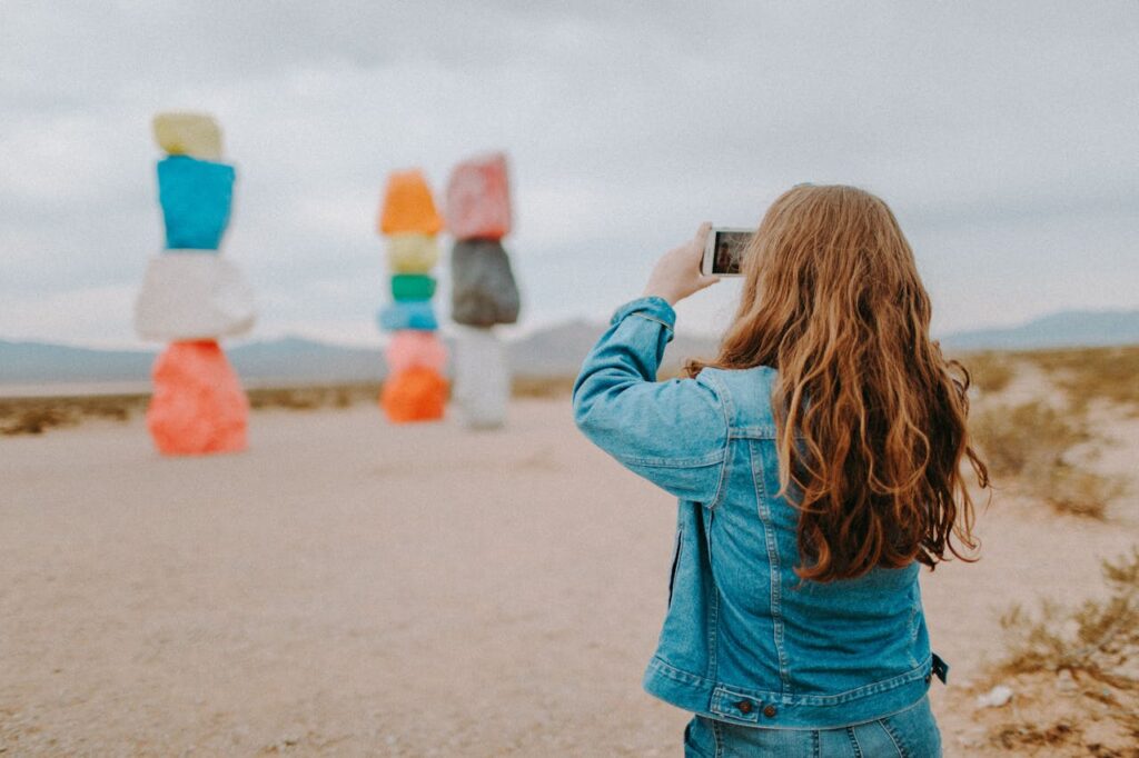 woman in denim jacket taking a picture