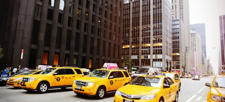 yellow taxi vehicles on the street
