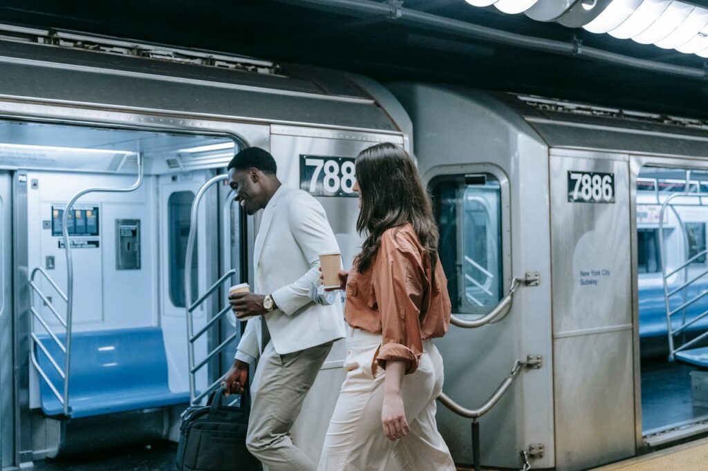 man and woman walking into a train