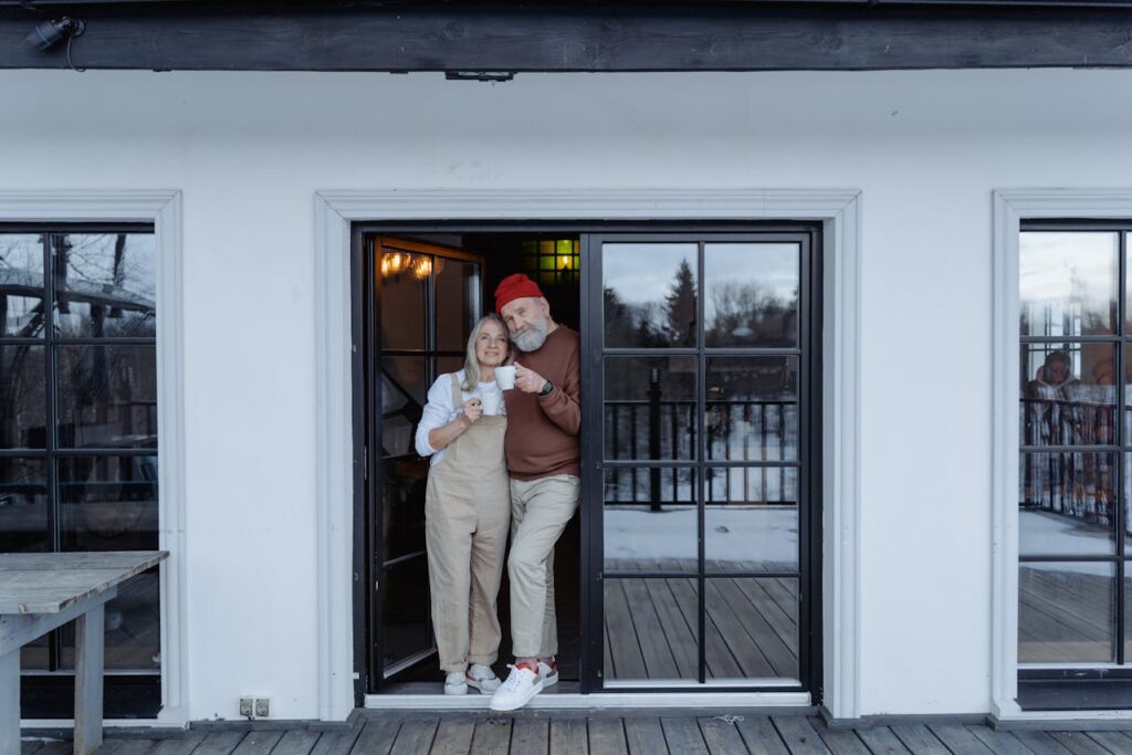 senior couple standing at the door