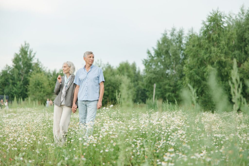 a couple standing in a grass field