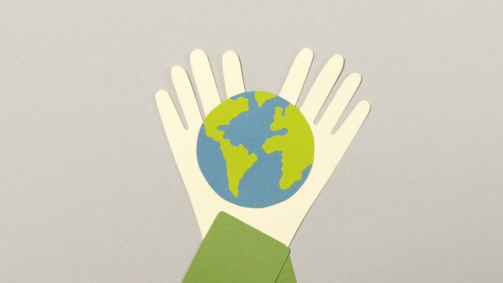 a paint of hands holding planet Earth