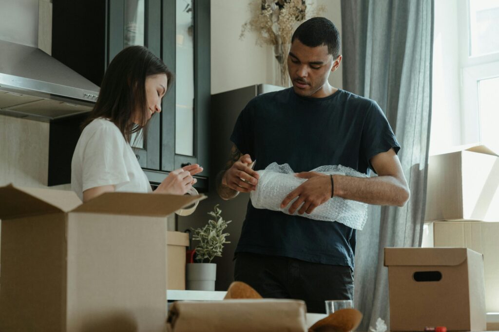 Man and woman packing boxes together