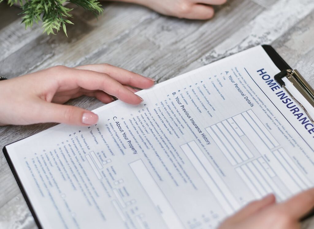 person holding home insurance papers