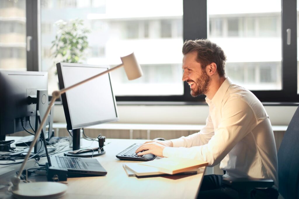a man sitting in an office beside a computer