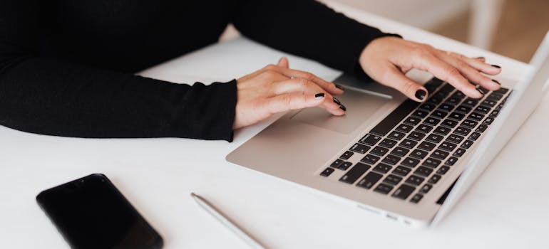 person typing on laptop