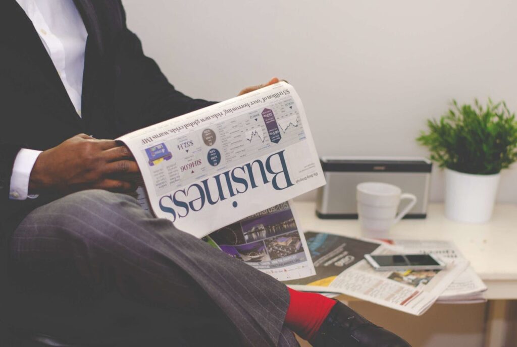 man reading newspapers