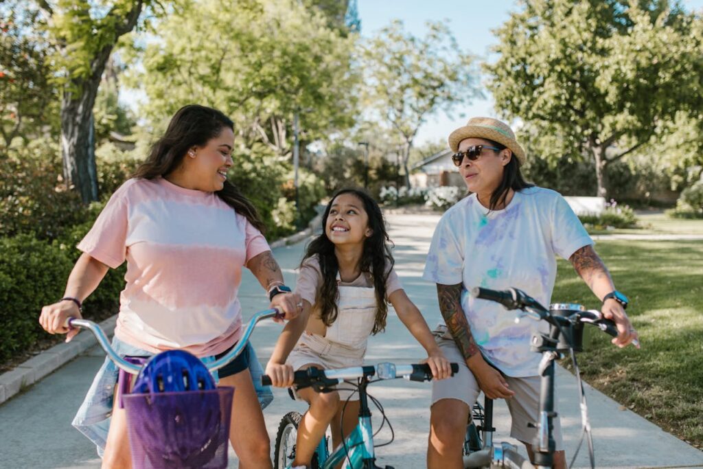 two women and a girl riding bikes
